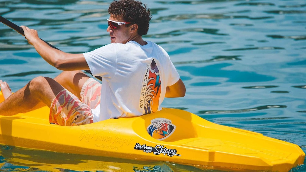 A person kayaking on a yellow kayak with a logo that reads 'Big Mama Kayak Skippy.' 3