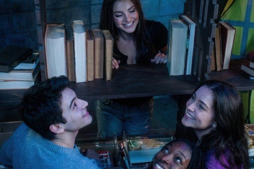 A group of people around a table with books. 2