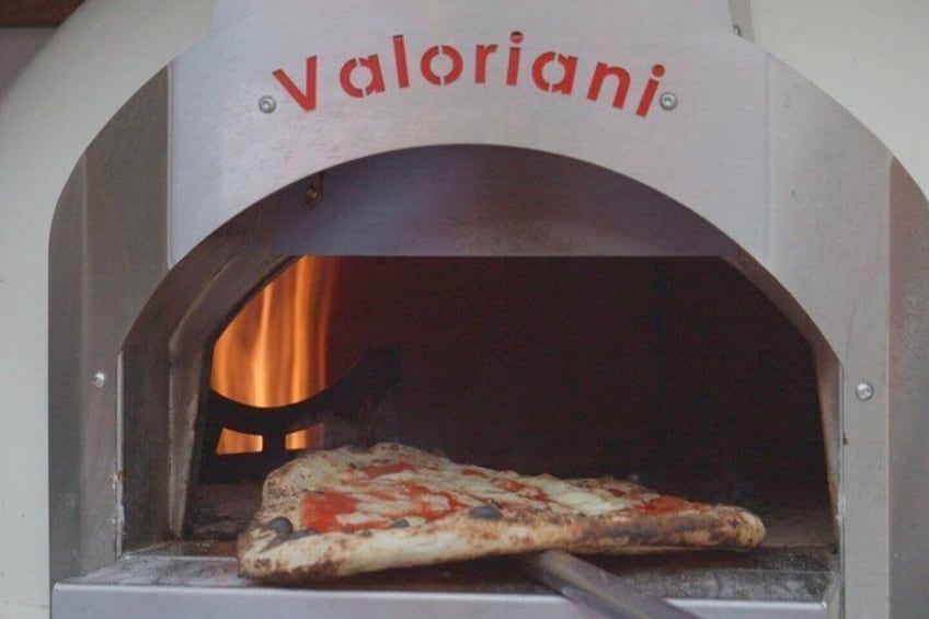 A pizza inside a Valoriani brick oven. 3