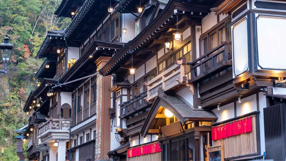 A traditional Japanese building with multiple balconies, wooden railings, and hanging lanterns. 2