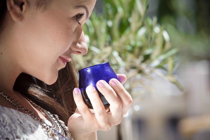A person holding a blue cup. 3