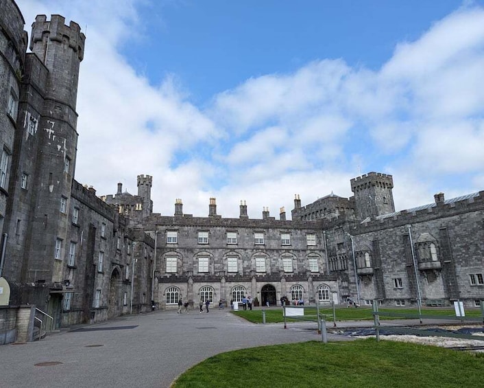 A historic castle with large stone walls, arched windows, and a central courtyard. 5