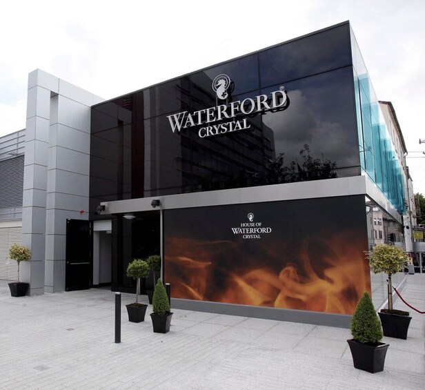 A modern building with a large glass facade and the 'Waterford Crystal' logo. 1