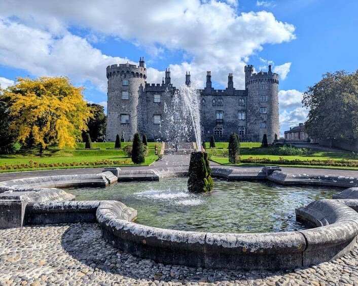 A castle with a fountain in the foreground. 4