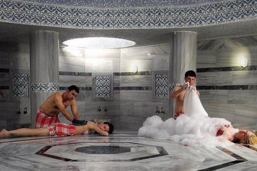A spa with marble floors, columns, and decorative tiles. 5
