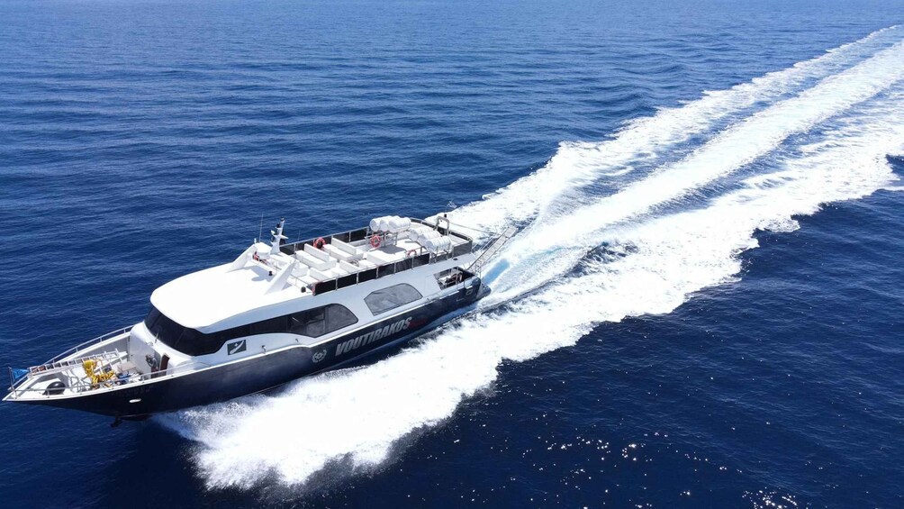 A large yacht moving through the ocean, creating a wake behind it. 2