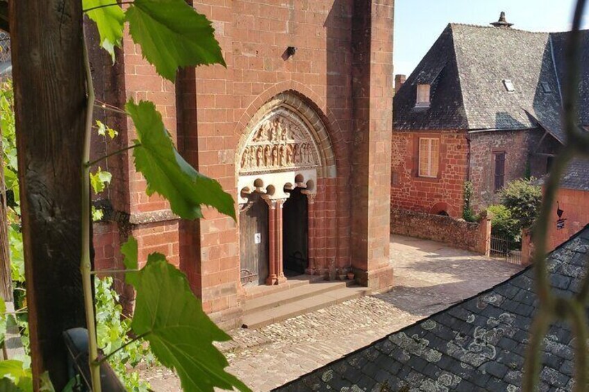 A red brick building with a pointed arch doorway and a cobblestone path. 5