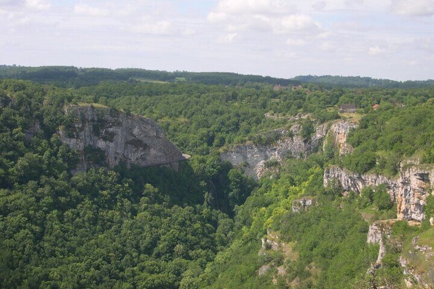 A mountainous landscape with dense forests and rocky cliffs. 4