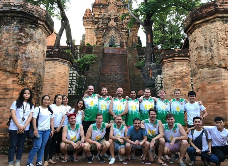 A group of people in front of a historic temple with a sign that reads 'THAPARONAGAR.' 4