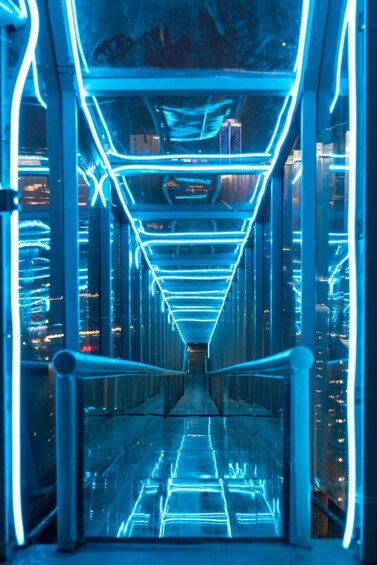 A futuristic corridor with blue neon lights and glass walls. 2