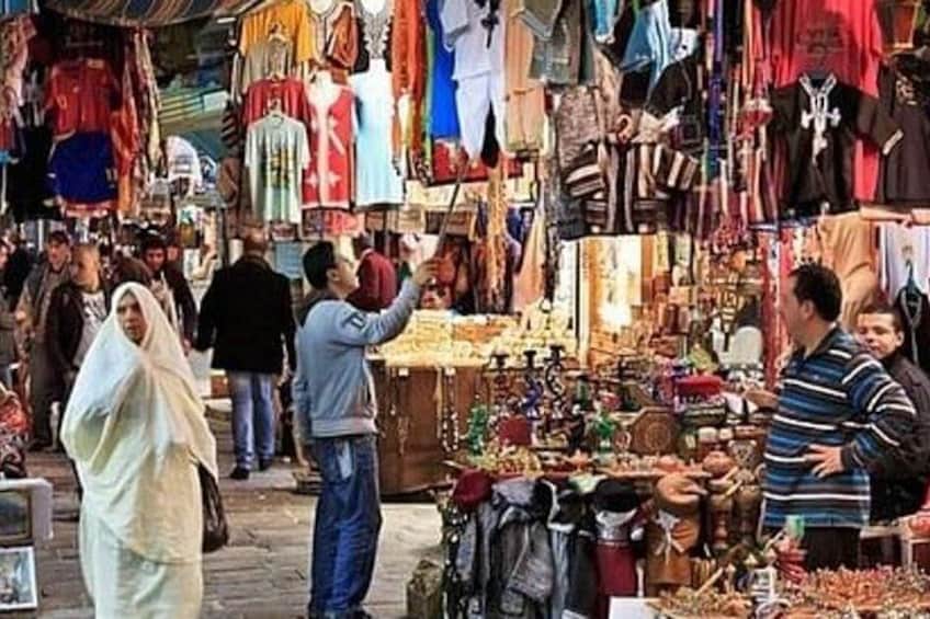 A bustling market with people browsing and shopping. 1
