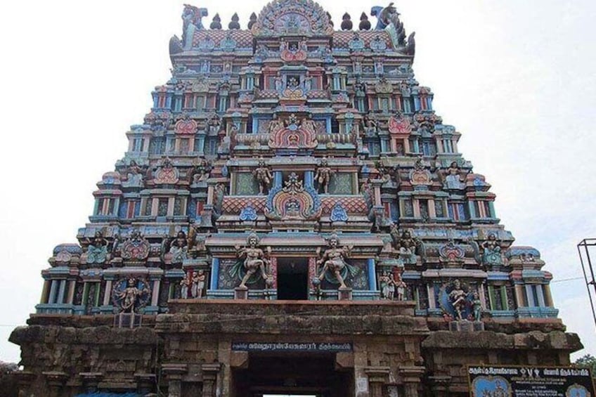 A multi-tiered temple with intricate carvings and statues. 4