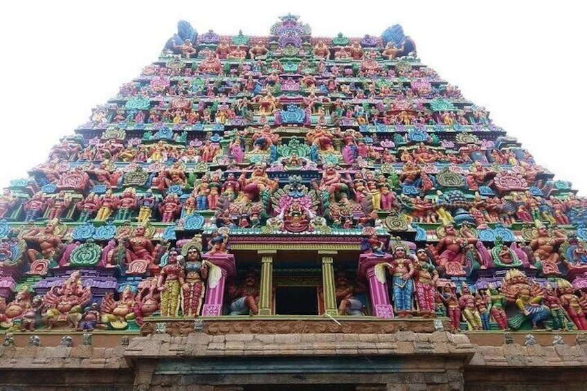 A temple with a multi-tiered structure adorned with colorful statues. 2
