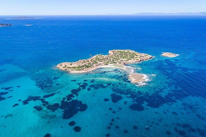 An aerial view of a small island with clear blue waters and coral reefs. 5