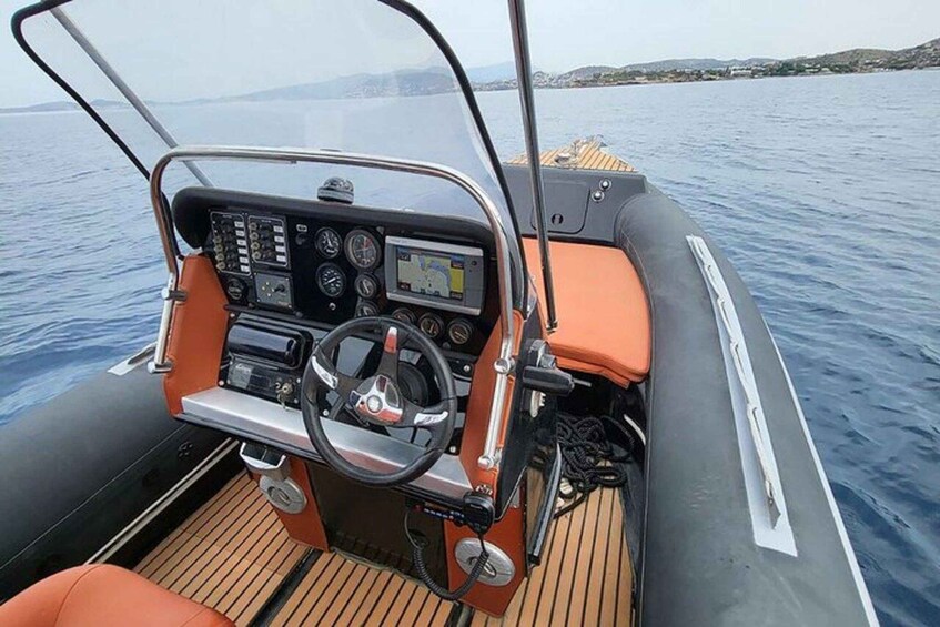 A boat's cockpit with a steering wheel, control panel, and navigation screen. 2