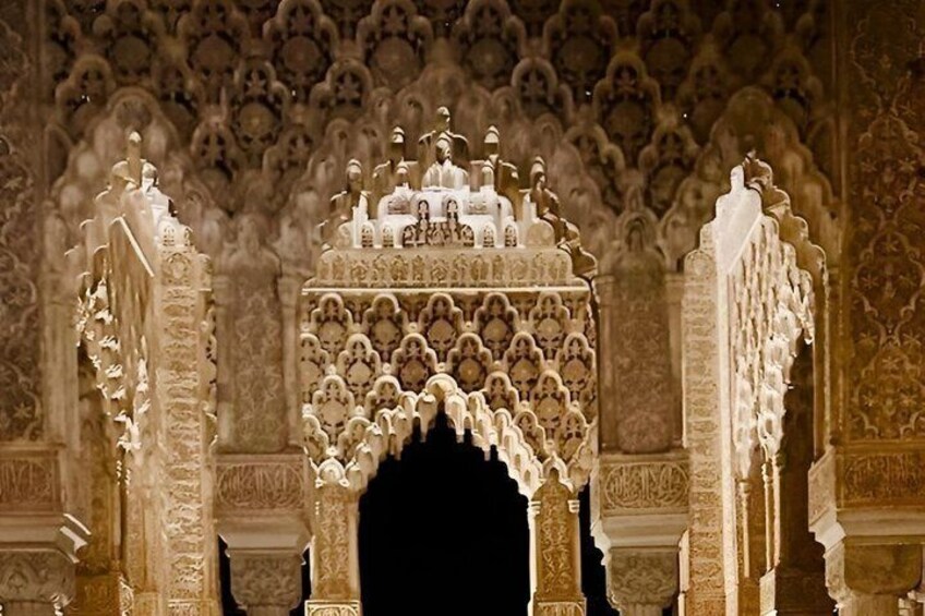 An ornate architectural archway with intricate carvings and a dark background. 3