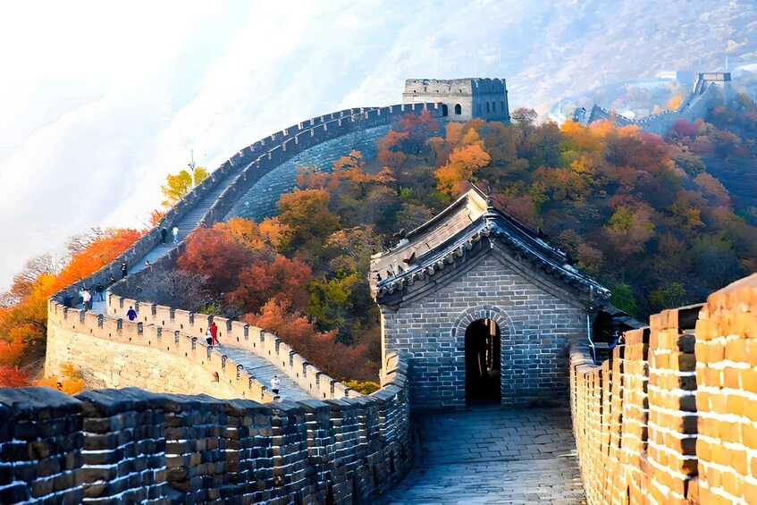 The Great Wall of China with autumn foliage and a traditional Chinese building. 1
