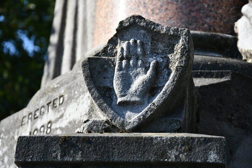 A stone monument with a hand emblem and the inscription 'ERECTED 1998'. 4