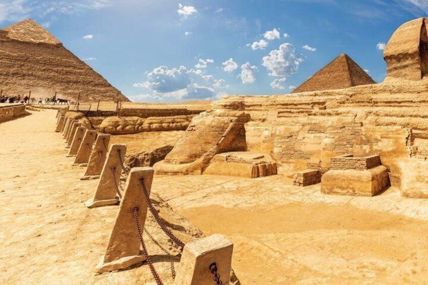 Ancient Egyptian pyramids, a clear sky, and a desert landscape. 3