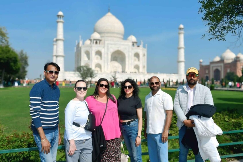 A group of people standing in front of the Taj Mahal. 3