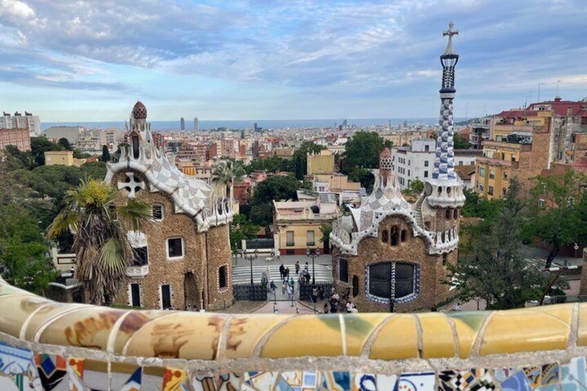 A view of Park Güell with its distinctive architecture and the cityscape in the background. 4
