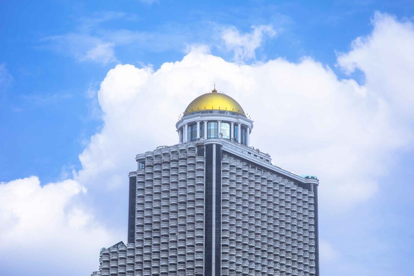A tall building with a golden dome and a grid of windows. 2