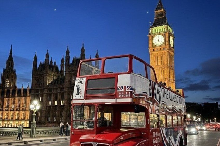 A red double-decker bus with 'The Classic Tour' written on it, in front of the Big Ben clock tower. 3