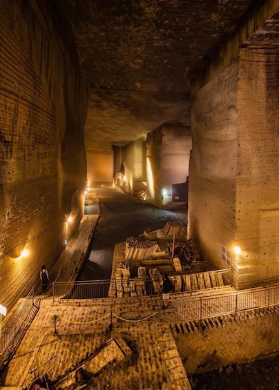 An underground passage with brick walls, a central pathway, and scattered debris. 1