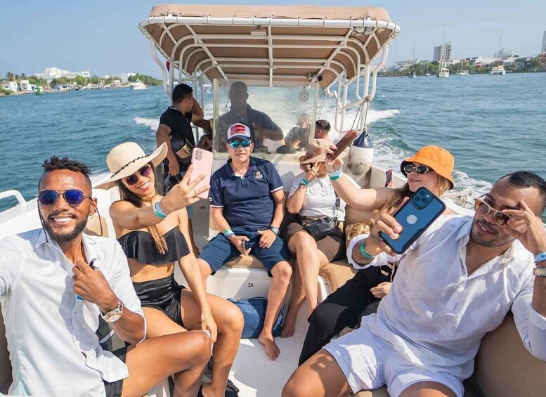 A group of people on a boat with a cityscape in the background. 3
