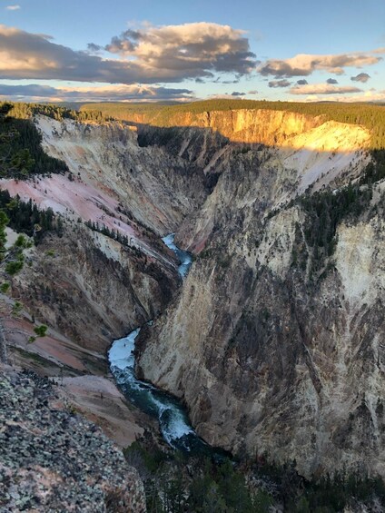 A canyon with a river, surrounded by forested areas. 1