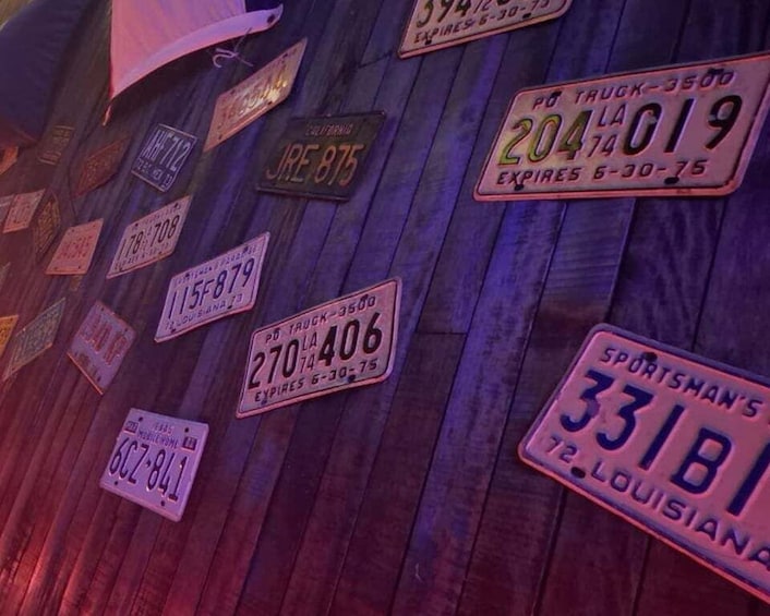 A wall with various license plates from different states. 5