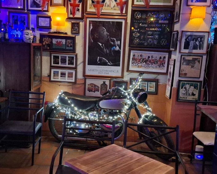 A motorcycle decorated with lights, surrounded by framed pictures and memorabilia. 1
