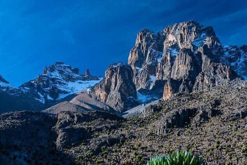 A rugged mountain landscape with rocky outcrops and sparse vegetation. 1