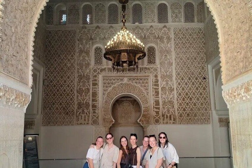 An ornate interior with intricate patterns and a chandelier. 3