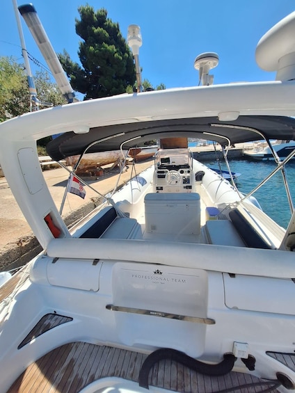 A boat's deck with a steering wheel, control panel, and a 'PROFESSIONAL TEAM' sign. 3