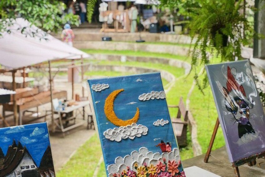 Outdoor art displays with a blue background, a crescent moon, and clouds. 5