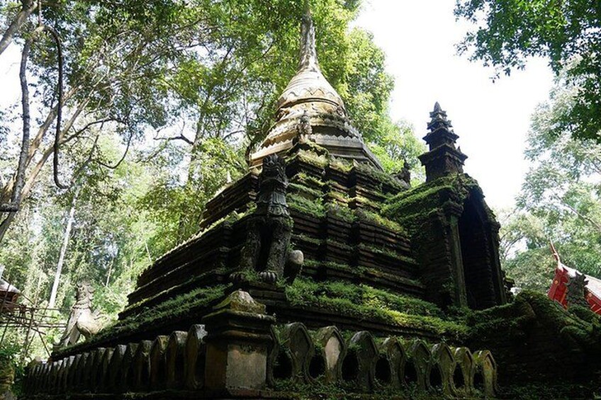 A temple with a tiered roof, surrounded by lush greenery. 3