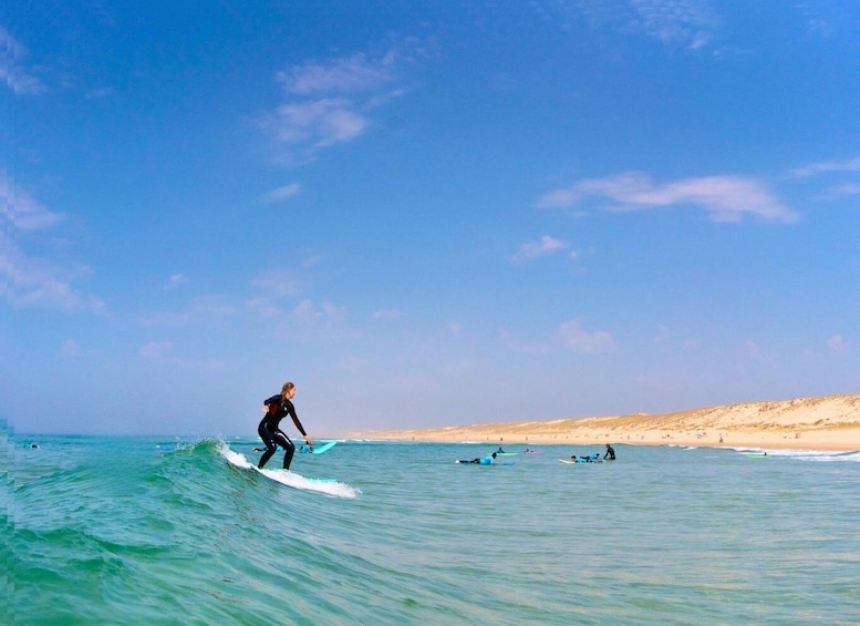 A surfer riding a wave on a clear day at the beach. 1
