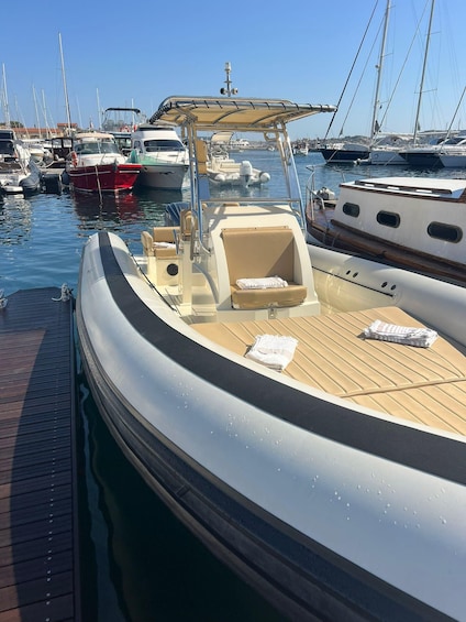 A marina with multiple boats docked, featuring a wooden deck and a covered seating area. 2