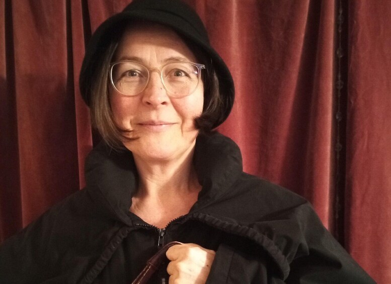 A person wearing a black hoodie and glasses. 4