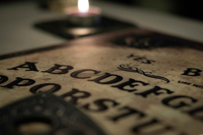 A close-up of an old, worn book with the letters 'A B C D E F G H I J K L M N O P Q R S T U V W X Y Z' visible. 2