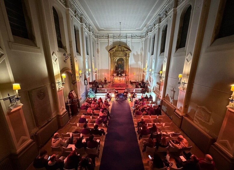 A church interior with pews arranged in rows facing an altar. 2