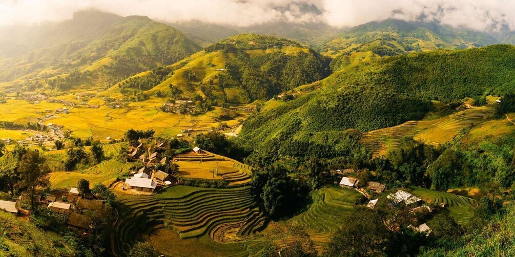 Terraced rice fields, small houses, and lush green hills. 2