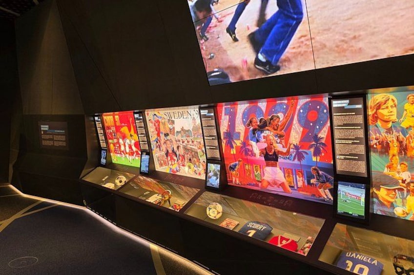A museum exhibit with various sports memorabilia and posters. 2