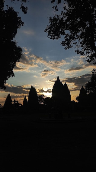 A silhouette of temple spires against a sunset sky. 1