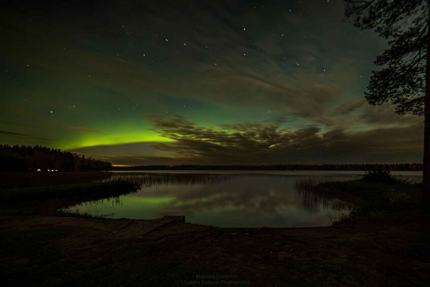 A night sky with the aurora borealis over a calm lake. 5