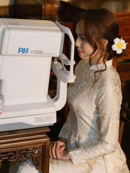 A person sitting in front of an RM-A7000 auto-refractometer. 4