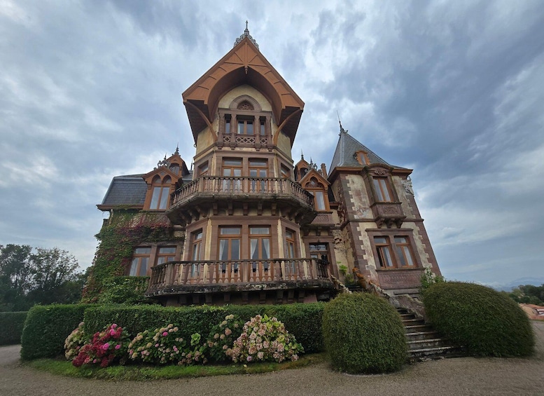 A large, ornate mansion with a prominent turret and a balcony. 1