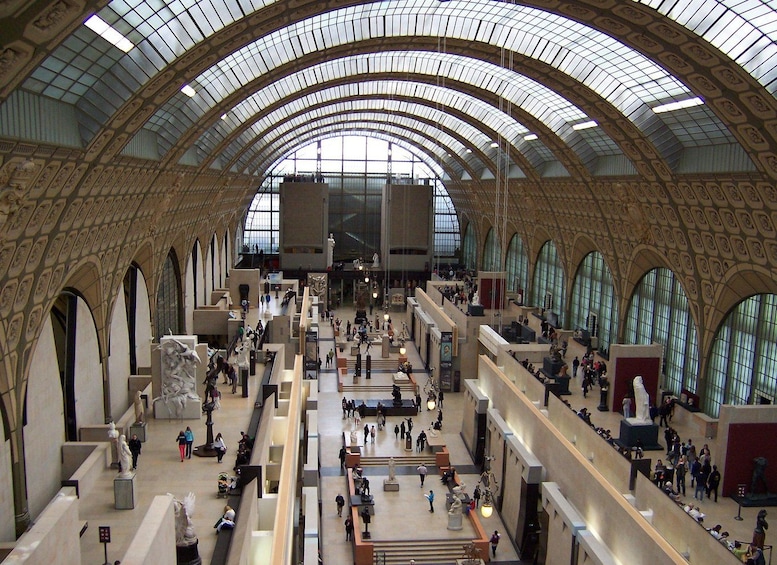 A spacious, multi-level atrium with high arched ceilings and large windows. 2