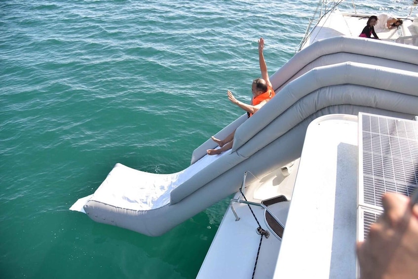 A person sliding down a water slide on a boat. 5